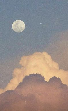 the moon is shining in the sky above some clouds