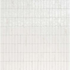 a white tiled wall with small squares on it