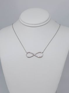 Beautiful sterling silver infinity Necklace with this cubic zirconia, Inspired by ancient infinity signs, meaning eternal connection It like the endless love between lovers, families, and friends. I recommend putting your jewelry on last when getting ready, as direct exposure to hair-styling products and perfume will often also damage the metal and gemstones. Do NOT use jewelry when swimming in chlorinated, thermal or salt water OR when showering. Also avoid wearing silver while exercising as th Infinity Jewelry With Diamond Accents For Gift, Silver Infinity Jewelry, Silver Infinity Jewelry For Anniversary, White Gold Infinity Jewelry With Cubic Zirconia, White Gold Infinity Cubic Zirconia Jewelry, Cubic Zirconia Infinity Jewelry For Mother's Day, Sterling Silver Infinity Jewelry With Diamond Accents, Hypoallergenic Sterling Silver Infinity Jewelry, Hypoallergenic Infinity Sterling Silver Jewelry