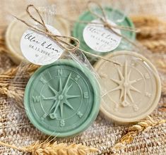 three soaps with labels on them sitting on some burlap and twine