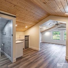 an empty room with wood floors and white walls is seen in this image from the inside