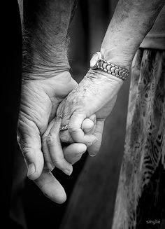 black and white photograph of two hands holding each other