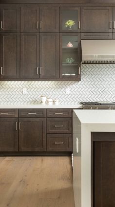 a kitchen with wooden cabinets and white counter tops