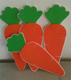 three cut out carrots sitting next to each other