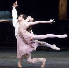 two ballerinas performing on stage during a performance