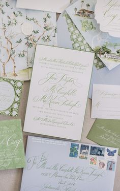 the wedding stationery is laid out on top of each other, including envelopes and cards