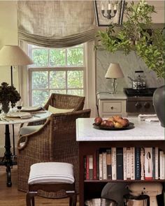 a room with a table, chair and bookshelf