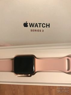 an apple watch is in the box with its pink band and black logo on it