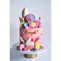 a pink cake with candy and candies on it