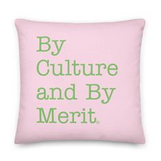 a pink pillow with green lettering that says by culture and by merit on it