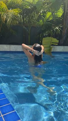 a person in a pool with a hat on their head