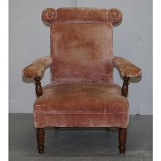 an old fashioned chair is upholstered in pink velvet