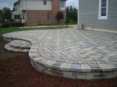 a brick patio in front of a house