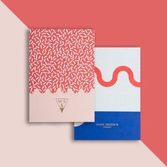 two notebooks sitting side by side on a pink and blue background with the same pattern