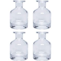 four clear glass vases sitting next to each other on a white background with one empty bottle in the middle