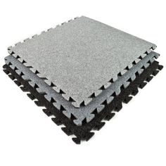 four pieces of foam with black and grey squares on top of each other, all in different