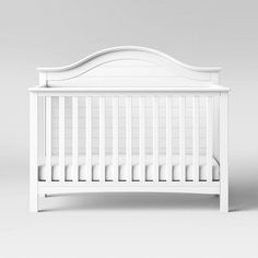 a white crib with no sheets on it