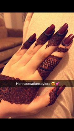 henna designs for hands and feet with red nail polish on the toes, which are decorated