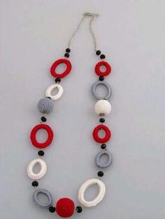 a red, white and grey necklace with black beads