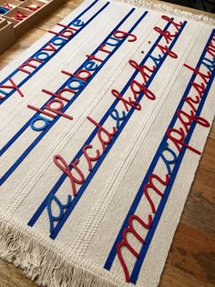 a rug with writing on it sitting on top of a wooden floor