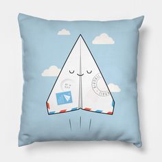 a blue pillow with a paper airplane on it