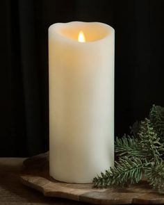 a white candle sitting on top of a wooden table