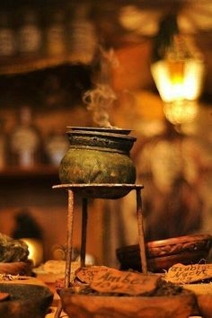 an old pot sitting on top of a wooden table