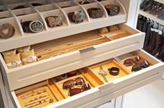 an open drawer filled with lots of different types of watch and jewelry items in it