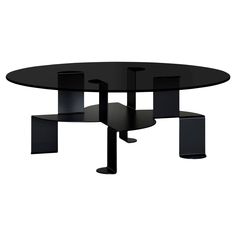 an oval glass table with black legs and two shelves on each side, in front of a white background