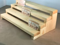 three wooden benches sitting next to each other on top of a carpeted floor in front of a blue wall