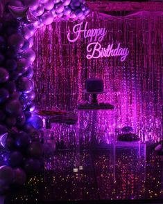 a purple and black birthday party with balloons