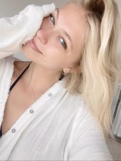 a woman with blonde hair wearing a white shirt