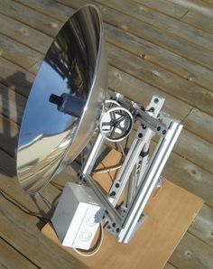 a satellite dish sitting on top of a wooden table