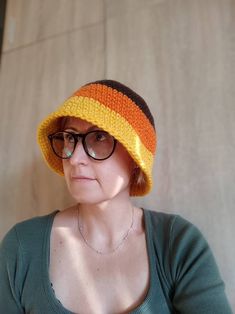 Crocheted winter woman bucket hat, made with soft yarn 25 % wool and 75% acrylic. Three coulor crochet bucket hat brown, orange, yellow. Size : US 6 7/8 - 7 ; S - M Head diameter 54 -56 cm. Free shipping on orders $35 and up to US buyers Trendy Brown Knitted Hat, Retro Yarn Beanie Hat, Handmade Retro Crochet Hat For Winter, Retro Handmade Crochet Hat For Winter, Retro Winter Crochet Hat Made Of Yarn, Handmade Brown Cloche Hat With Wide Brim, Trendy Handmade Hats For Fall, Yellow Crochet Bucket Hat One Size, Hand Knitted Bucket Hat