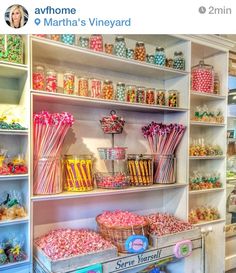 an assortment of candy and candies on display in a store with shelves full of sweets