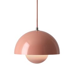 a pink pendant light hanging from a ceiling