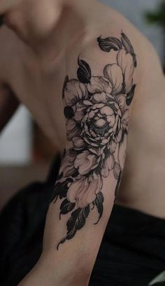 a man with a flower tattoo on his arm