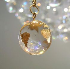 A beautiful handmade globe necklace made with jewelry grade resin and gold leaf!  Gift idea for her. Earth planet pendant necklace celestial globe sphere necklace charm accessory jewelry #resin #handmade #jewelry #jewellery #celestial #earth #planet #gold #necklace #pendant #globe #feminine #elegant #gift #charm #ethereal #gold #goldjewelry #goldjewellery #goldleaf #deintyjewelry Celestial Globe, Planet Pendant, Accessory Jewelry, Jewelry Resin