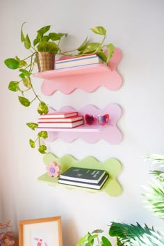 some books and plants are hanging on the wall