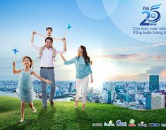 the family is flying kites in the sky over the cityscape and water