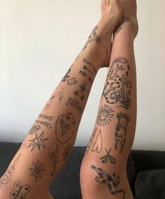 two people with tattoos on their arms and legs