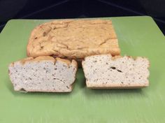 two pieces of bread sitting on top of a green cutting board