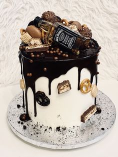 a decorated cake with chocolate, marshmallows and pretzels