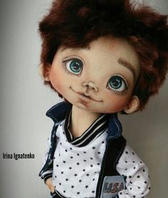 a close up of a doll with blue eyes