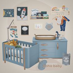 there is a baby crib in the room with pictures and toys on the wall