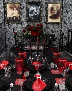 the table is set with black and red dishes