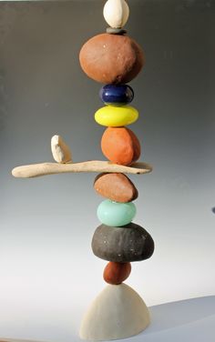 a stack of rocks sitting on top of a wooden stick