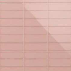 a pink tiled wall with white tiles on it