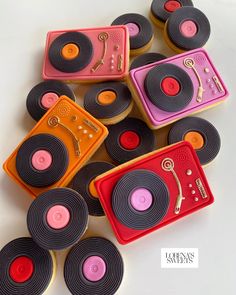 many different colored record player cookies on a table