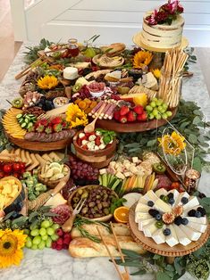 a table filled with lots of different types of food and desserts on top of it